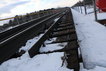 railway in winter. Rails and sleepers - a road for locomotives and electric locomotive covered with...