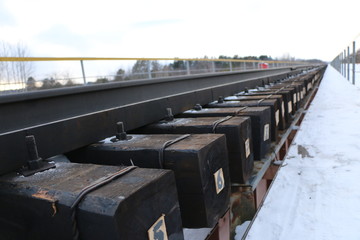 railway in winter. Rails and sleepers - a road for locomotives and electric locomotive covered with...