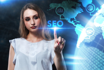 The concept of business, technology, the Internet and the network. A young entrepreneur working on a virtual screen of the future and sees the inscription: SEO