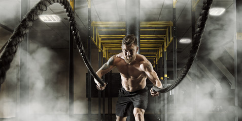 Man working out with battle ropes