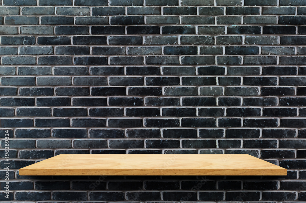Poster empty wood board shelf at black brick wall background,mock up for display or montage of product or d