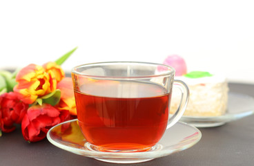 birthday cake with a Cup of tea and a Tulip flower