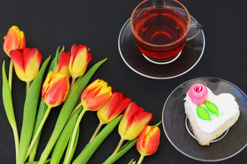 birthday cake with a Cup of tea and a Tulip flower