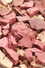 Heap of various crashed makeup products