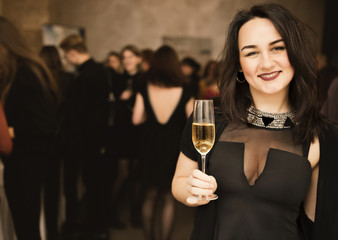 beautiful young smiling woman with a glass in hands