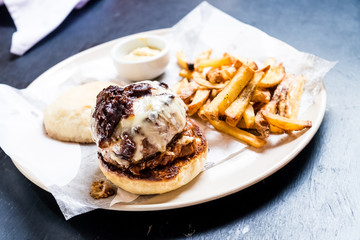 shot of gourmet hamburger, ready to be eaten, fries on the side
