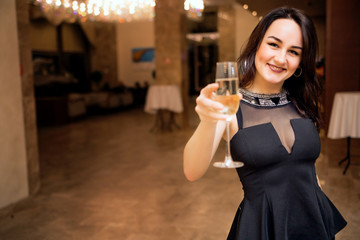 beautiful young smiling woman with a glass in hands