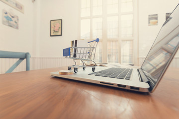 Business and finance concept, Credit card in shopping cart and bitcoin on laptop for E-Commerce online shopping.