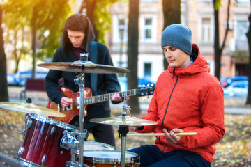 Music street performers on autumn outdoor. Middle section of body part. Body part hands give concerts for people. Color tone on shiny sunlight background. People make living by concerts.