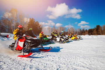 Snowmobile. Snowmobile races start in snow. Concept winter sports, racers.