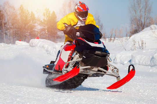 Snowmobile. Snowmobile races jump in snow. Concept winter sports, racers.