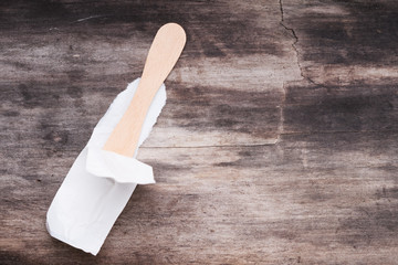 Spoon in torn packaging