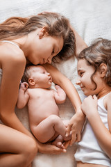 Older sister holding a newborn baby.