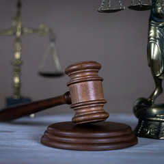 Law and Justice concept. Mallet of the judge, books, scales of justice. Gray stone background,...