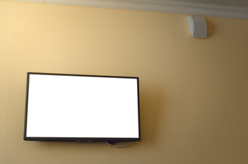 TV set with blank screen mounted on yellow wall. TV template with copy space.