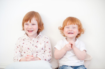 Laughing funny redhead brother and sister