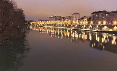 Fototapeta premium Po river flowing in Torino city, Italy, Murazzi docks, night view
