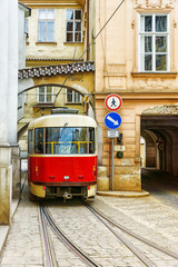 Fototapeta na wymiar red vintage tram in the old streets of Prague