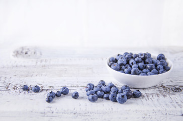 Berries in a bowl / Blueberry in a white bowl on a wooden white table