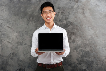 Portrait of a smiling young asian man dressed in shirt