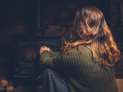 Woman getting warm by the fire