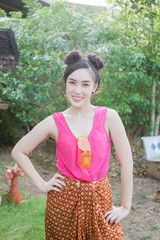 Young Asian woman in Traditional Costume of Thailand playing water in Songkran festival