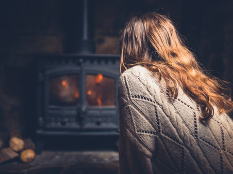 Woman getting warm by the fire