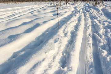 Fototapeta na wymiar A layer of snow near the ski track.