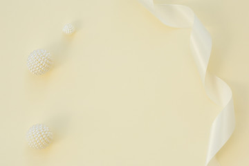 Naklejka na ściany i meble Styled stock photo. Feminine wedding desktop mockup. White roses, satin ribbon, beads on delicate beige background. Copy space. Top view. Picture for blog.