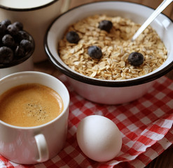 healthy eating and diet concept: oatmeal, boiled egg, milk, fres