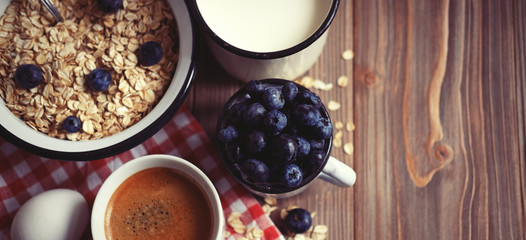 A healthy breakfast - oatmeal, boiled egg, milk, fresh berries a