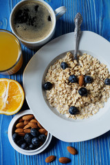 Oatmeal porridge with fresh blueberries,  almonds, coffee and or