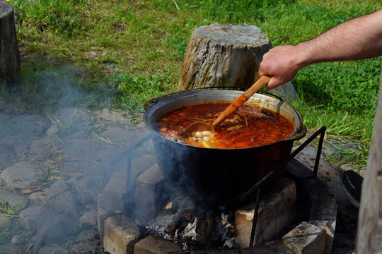 Bograch. Soup with paprika, meat, bean, vegetable, dumpling. Traditional Hungarian Goulash in cauldron. Meal cooked outdoors on an open fire. Delicious and healthy food popular in Central Europe.