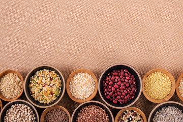 Variety of rice and grains in bowls on linen tablecloth