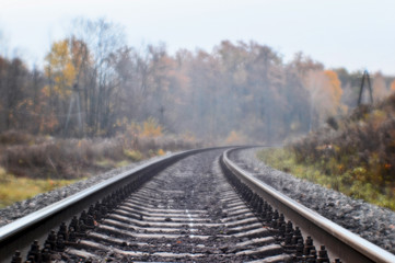 Fototapeta na wymiar Soft blur photos taken on the soft lens. Railroad in autumn stretches into the distance.