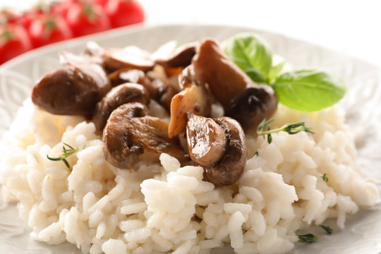 Tasty risotto with mushrooms on plate, closeup