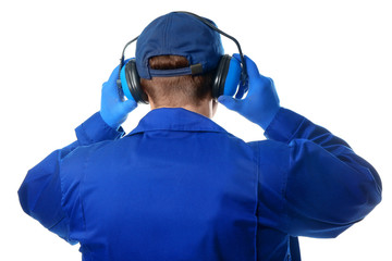 Male worker with hearing protectors on white background