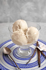 Dessert bowl with delicious vanilla ice cream on table
