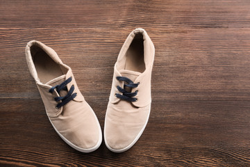 Casual male shoes on wooden floor