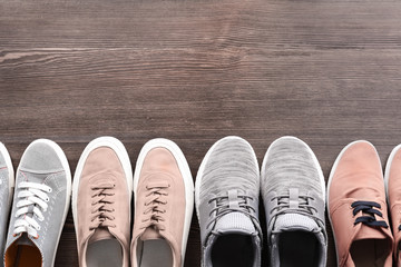 Different male shoes on wooden floor