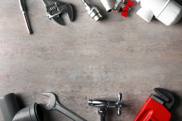 Plumber's items on textured background