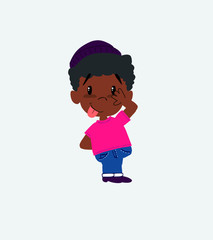 Black boy in a swimsuit sticks out his tongue in gesture of funny shyness.