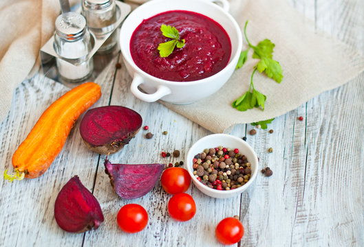 summer cream soup made from beets and carrots with greens and spices with a detoxification top view. Diet, clean food, weight loss, the concept of vegetarian food.