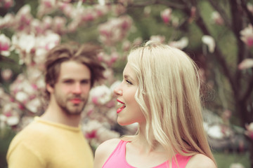 family couple in spring magnolia flower.