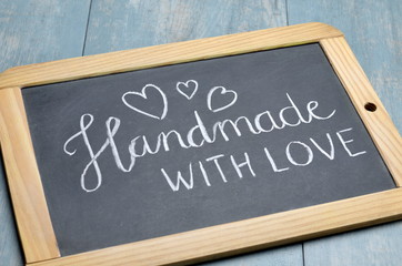 "HANDMADE WITH LOVE" with hearts written on chalkboard
