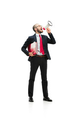 Fototapeta premium Side view of a man screaming on the megaphone over white background