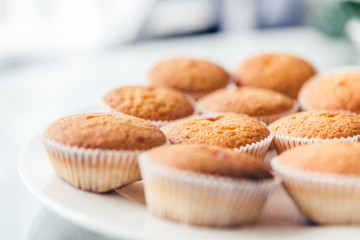 close-up view of delicious homemade muffins on white plate