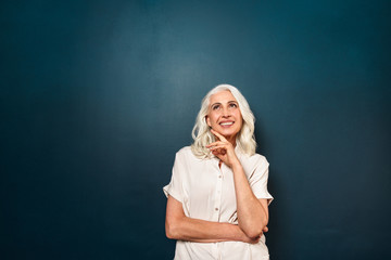 Old cheerful woman looking aside isolated