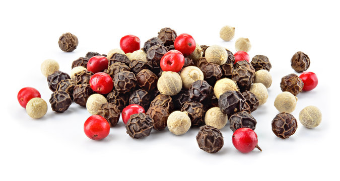 Mix of different peppers. Black, red and white peppercorns isolated on white background. Heap of spice. Full depth of field.
