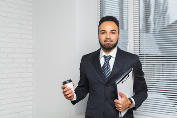 Business man in a business suit and a cup of coffee